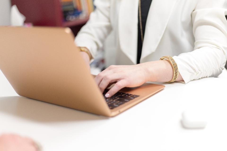 A person typing with focus at a clean desk