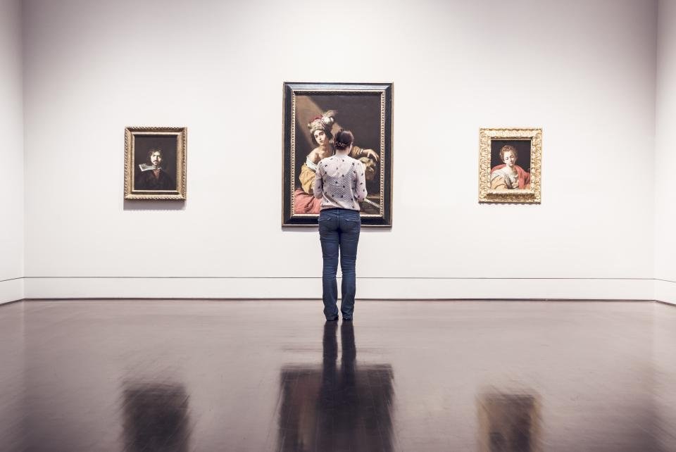 Framed artworks arranged on a gallery wall